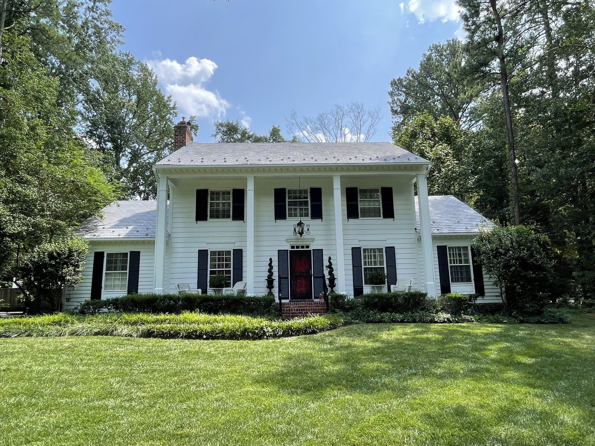 White exterior house with black shutters and freshly painted siding Richmond VA